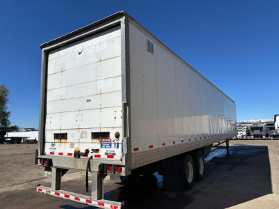 Hyundai dry van trailer with roll-up rear door, white exterior, dual rear axles, side vents, and light reflectors.