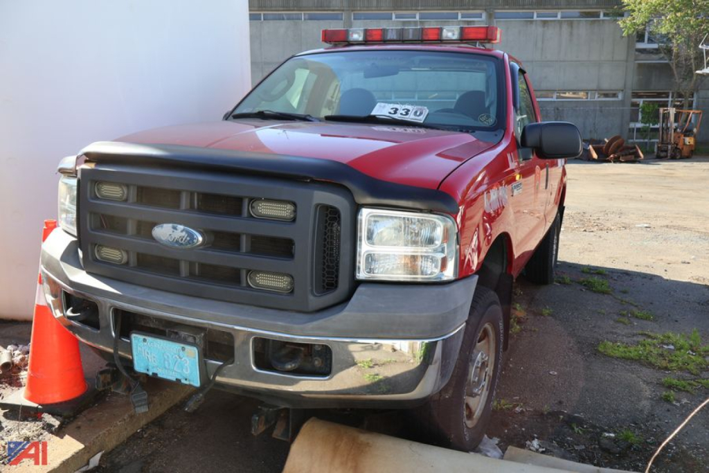Ford F-250 Super Duty pickup truck front view showing grille headlights and red exterior