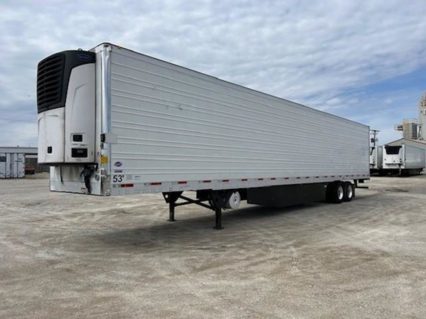 Utility reefer trailer with silver aluminum siding and front refrigeration unit; 53' long, tandem axles, landing gear down, stock number KTS1914.
