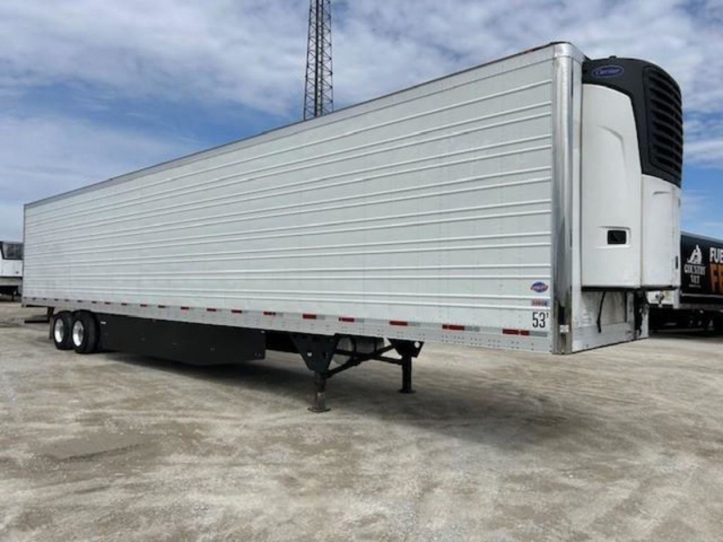 Trailer side view of a 2019 Utility Reefer refrigerated semi-trailer showing a front cooling unit, silver exterior, tandem axle, and landing gear.