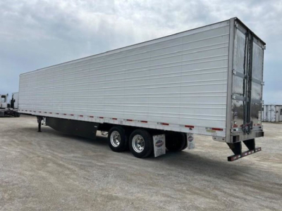 Trailer side view showing 2019 Utility refrigerated trailer with aluminum panel sides and triple axle.