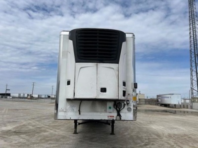 Reefer trailer rear view showing transport refrigeration unit on a 2019 Utility Reefer, with white body, black cooling unit grille, and support legs visible.