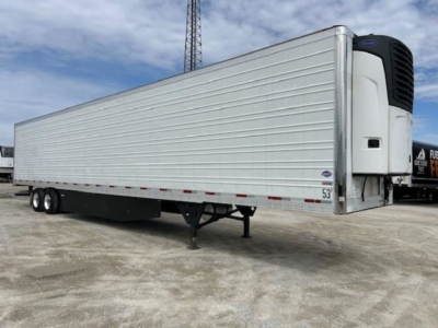 Trailer side view of a 2019 Utility Reefer refrigerated semi-trailer showing a front cooling unit, silver exterior, tandem axle, and landing gear.