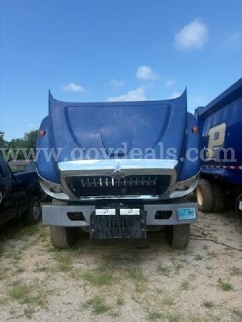 Front view of 2011 International 7500 truck with blue hood open showing grille and bumper area.