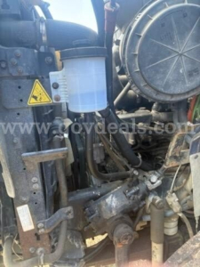 Image shows engine bay of a 2011 International 7500 truck with visible fluid reservoir and front engine components.