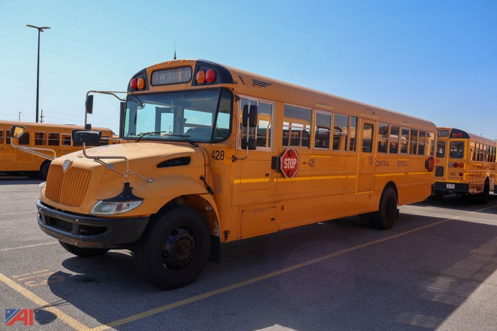 Yellow IC Corporation CE Series school bus in a parking lot, front-left view showing Stop sign and bus number 420.