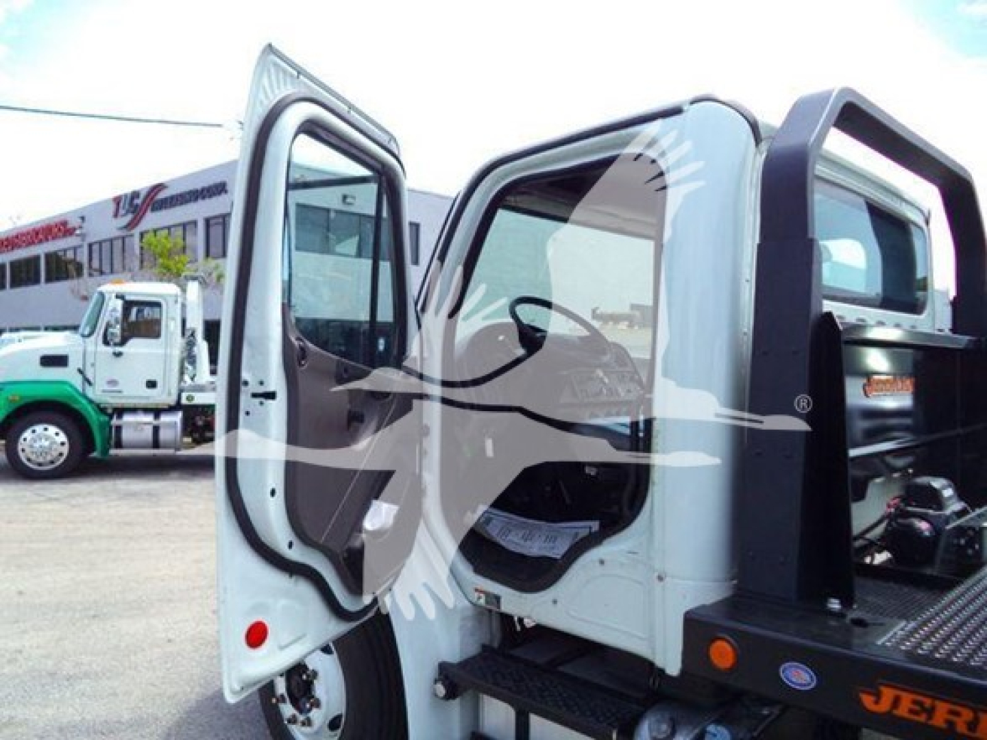 Frieghtliner M2 106 cab interior with open doors showing steering area and entry step.