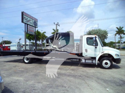 Freightliner Business Class M2 106 flatbed truck side view showing long wheelbase and flatbed.