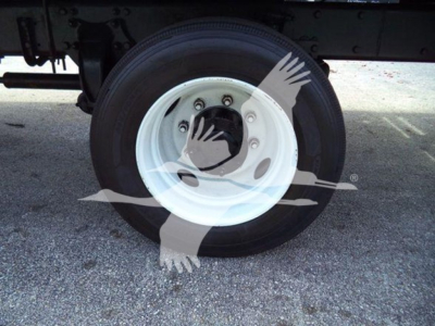 Wheel of a Freightliner Business Class M2 106 truck showing white steel rim and tire undercarriage with watermark overlay.