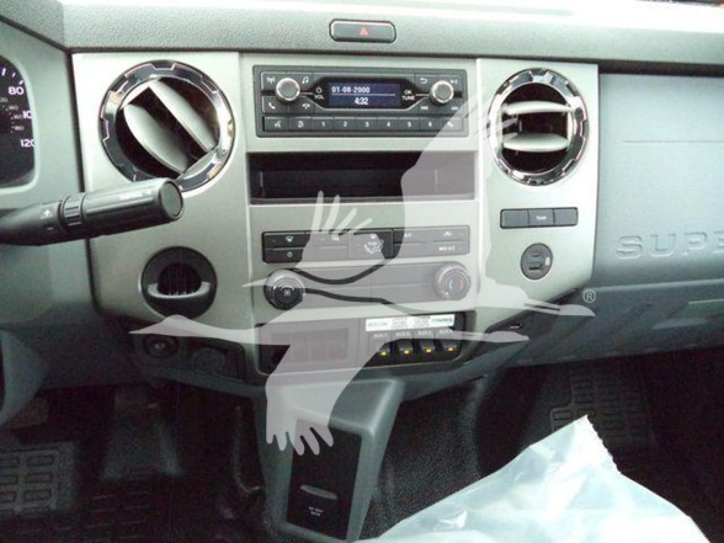 Ford F-750 Super Duty dashboard view showing center console and air vents with factory radio and control knobs.