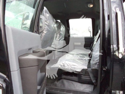 Ford F-750 rollback truck cab interior view showing front seat and plastic coverings.