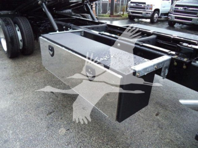 Ford F-750 rollback utility truck bed toolbox mounted under chassis showing metal toolbox with latches.
