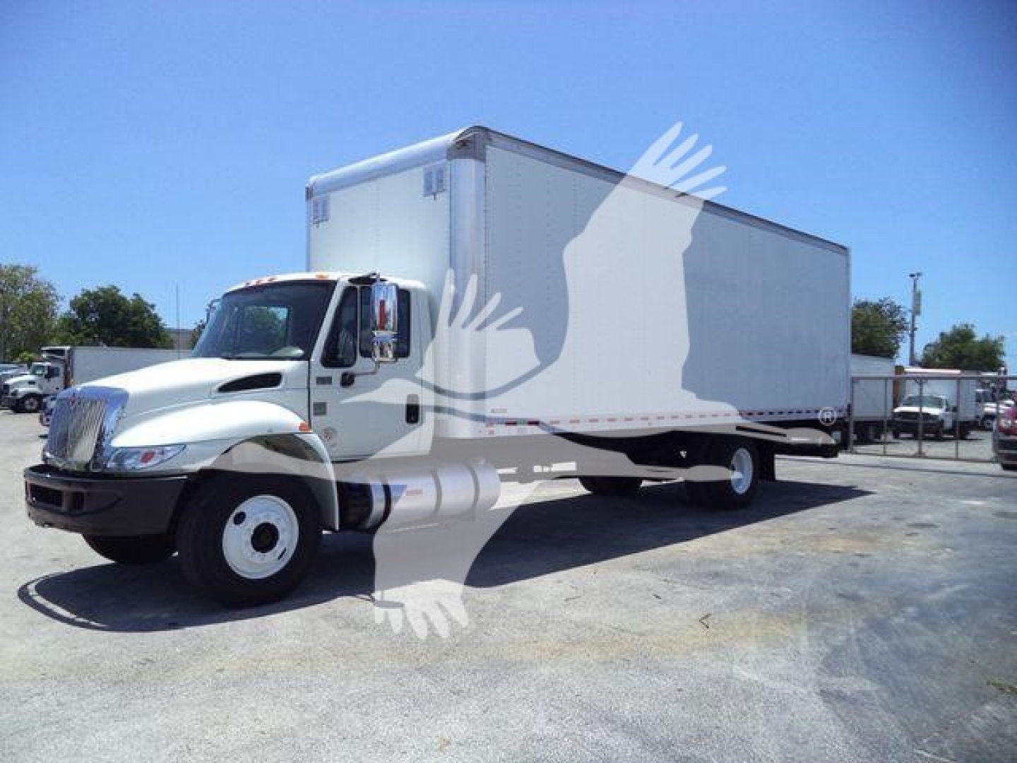 Box truck from a side view, 2019 International Durastar 4300, white box body, no visible branding on the cab side.