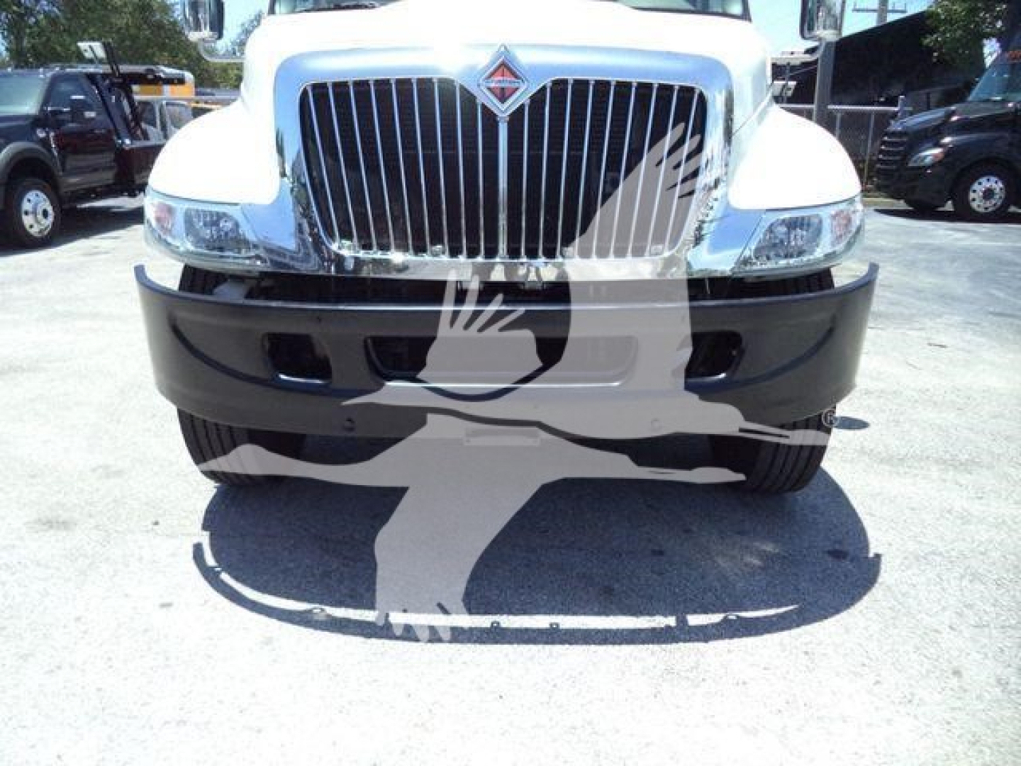 Truck front view showing grille and bumper of a 2019 International Durastar 4300 in a dealership lot.