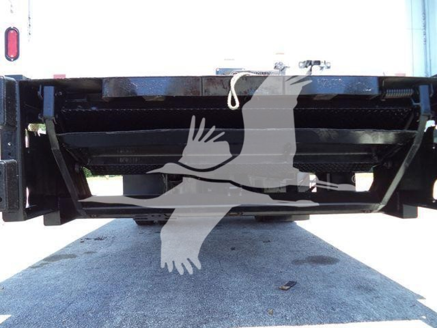 Truck rear showing hitch area and frame with clearance underbed view.