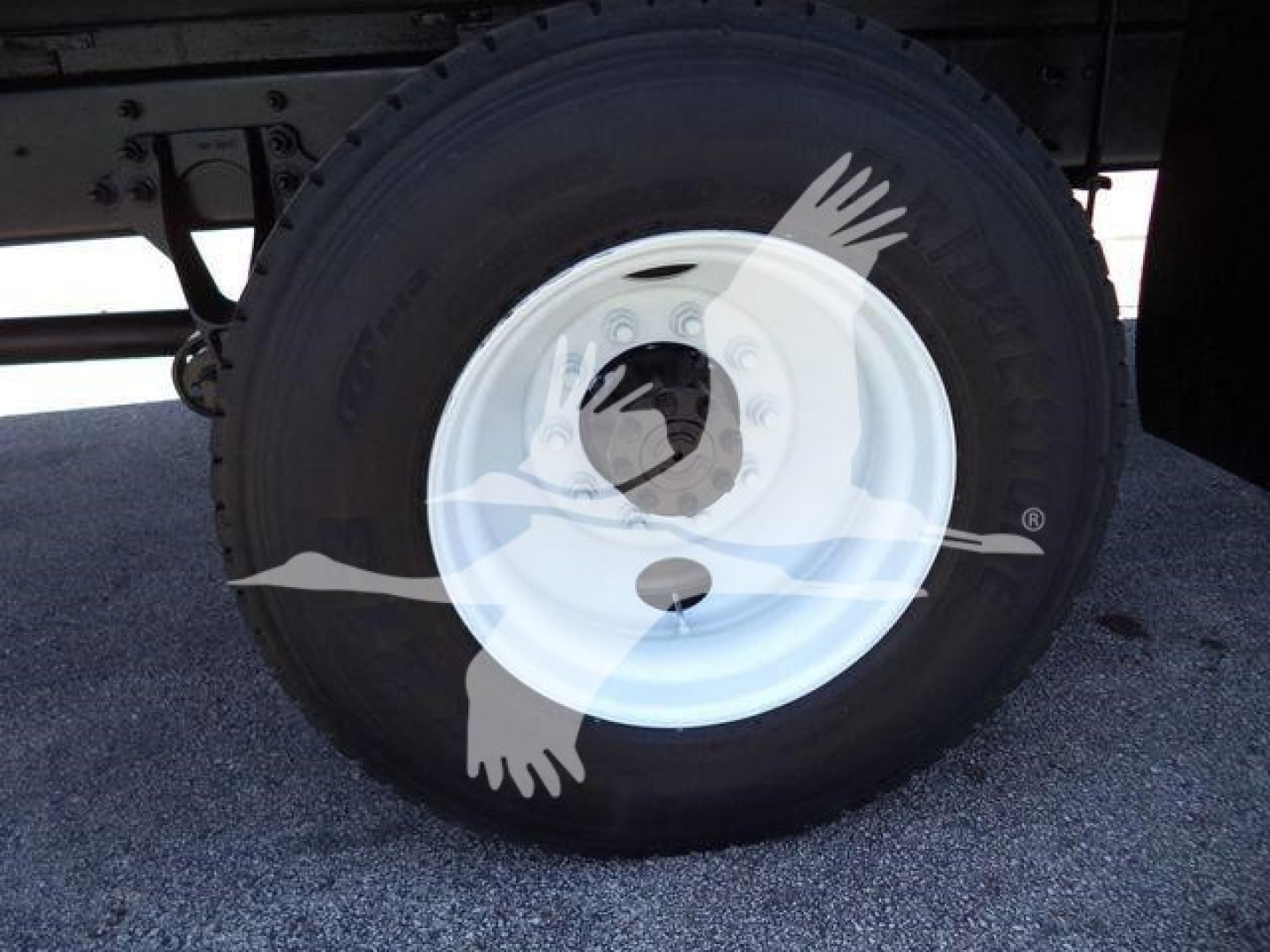 Wheel and tire on 2019 International Durastar 4300 truck showing white steel rim and tire with visible tread.