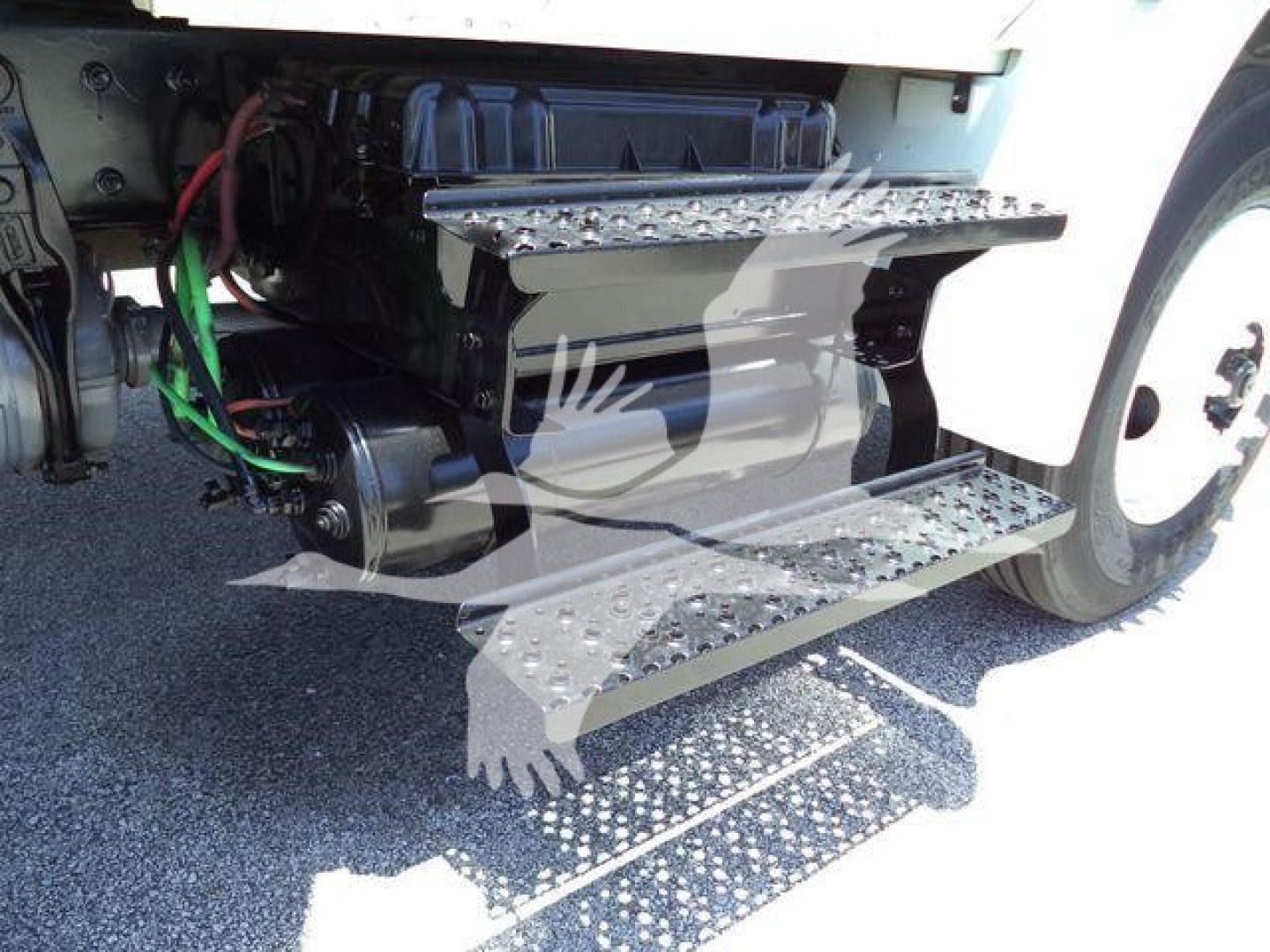 Truck side view showing steps and battery area under cab of a 2019 International Durastar 4300 with visible wiring and air intake.