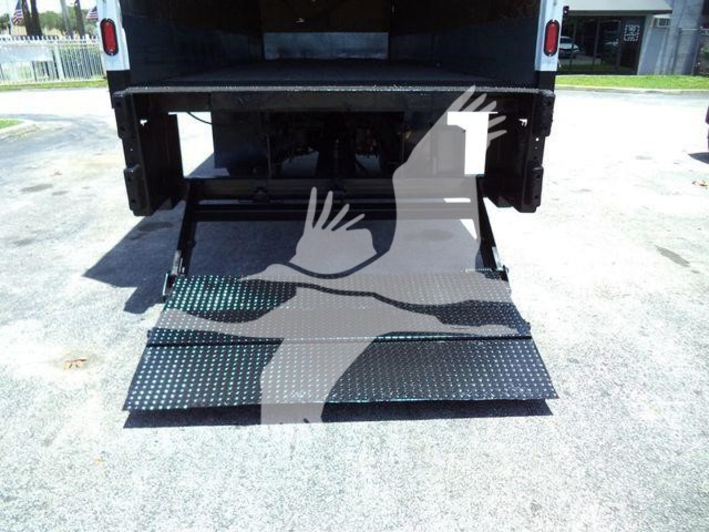 Truck bed with lowered ramp of a 2019 International Durastar 4300 in-service used truck showing the loading ramp.