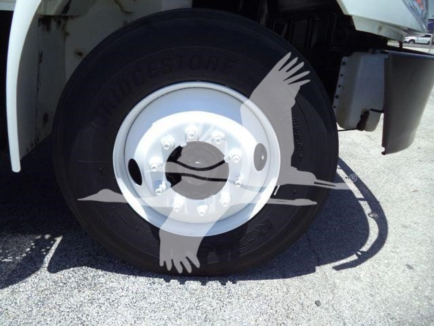 Truck wheel and tire close-up showing Bridgestone tire on International Durastar 4300 front axle.“