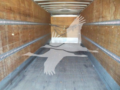 Interior of a 2019 International Durastar 4300 box truck cargo area with wood-panel walls and steel tracks.