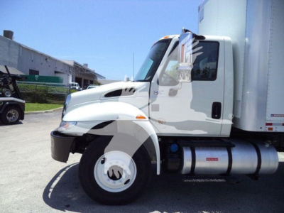 Truck cab side profile of 2019 International Durastar 4300 with box body, showing front wheel, fuel tank, and door, stock number T33961FM.