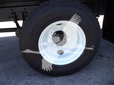 Wheel and tire on 2019 International Durastar 4300 truck showing white steel rim and tire with visible tread.