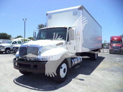 Box truck with white cab and cargo box in a dealership lot, International Durastar 4300 model.