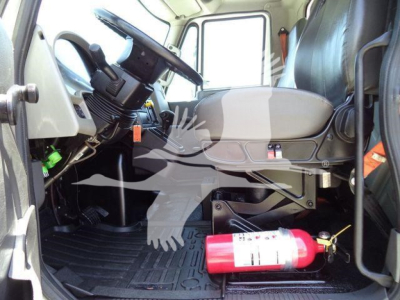 Cab interior of a 2019 International Durastar 4300 box truck showing steering wheel, driver seat, dashboard, and a red fire extinguisher on the floor.