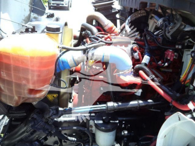 International Durastar 4300 engine bay showing coolant reservoir, hoses, and engine components.