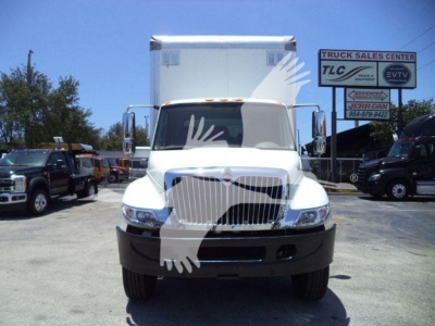 International Durastar 4300 box truck front view showing white cab and large cargo box.