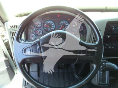 Truck interior showing steering wheel and dashboard gauges in a 2019 International Durastar 4300.