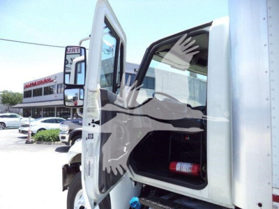 Truck cab interior and front door open showing storage area and a fire extinguisher; side mirror and part of box truck body visible.