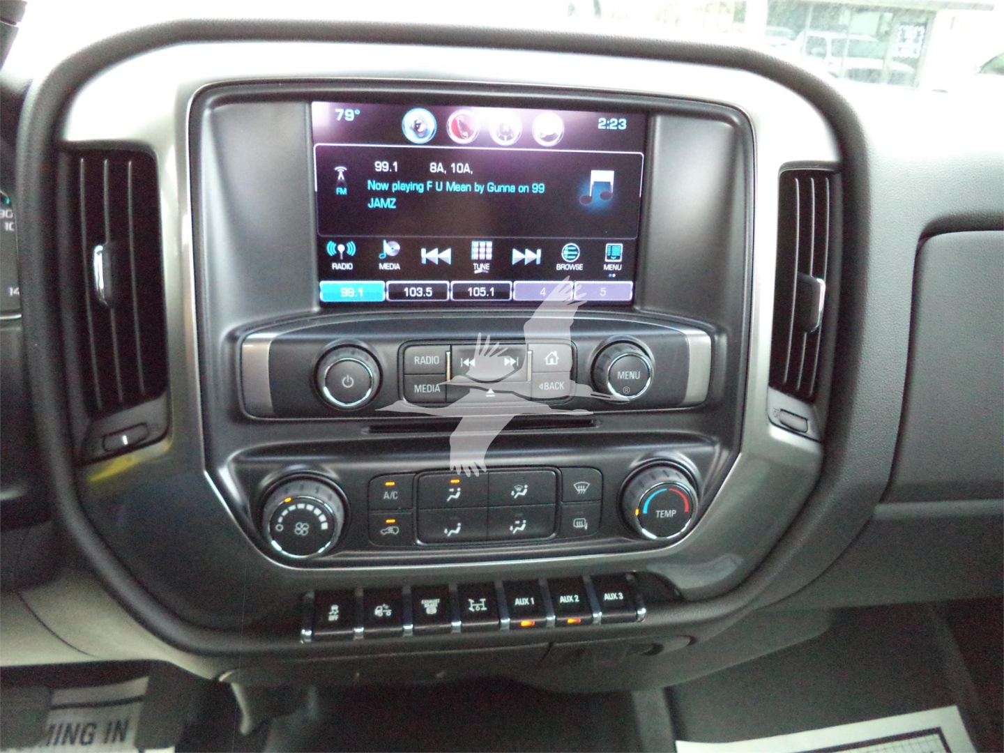 Dashboard and infotainment system of a new 2023 Chevrolet Silverado 6500HD rollback truck showing touchscreen and control knobs.