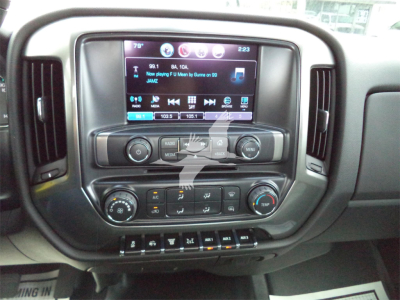 Dashboard and infotainment system of a new 2023 Chevrolet Silverado 6500HD rollback truck showing touchscreen and control knobs.