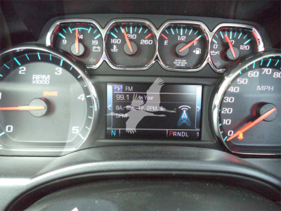 Dashboard of a Chevrolet Silverado 6500HD showing RPM gauge, speedometer, and a central infotainment display with FM radio text.