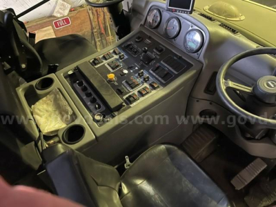 Cab interior of a 2021 Elgin Pelican sweeper showing dashboard with gauges, switches, and steering wheel.