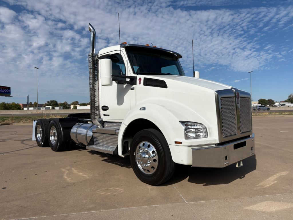 Kenworth T880 conventional daycab truck in white showing side profile and chrome fuel tanks with dual rear axles and stacked exhaust, VIN 1XKZD49X1RJ347416 not visible in image