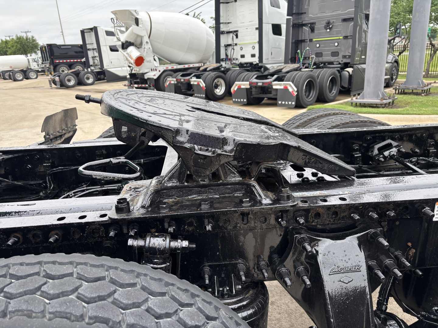Freightliner Cascadia 126 chassis with exposed frame and suspension after cab removed; visible components include crossmembers, air lines, and driveshaft area.
