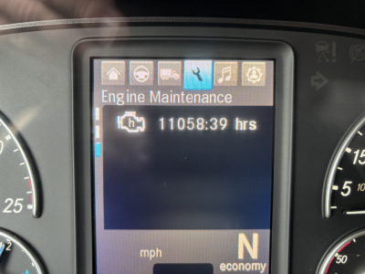 Truck instrument cluster display reading Engine Maintenance and hours 11058:39 hrs. Surrounding gauges visible.
