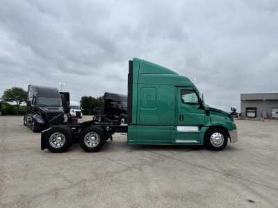 Freightliner Cascadia 126 tractor in a side profile view showing green cab and dual rear axles.
