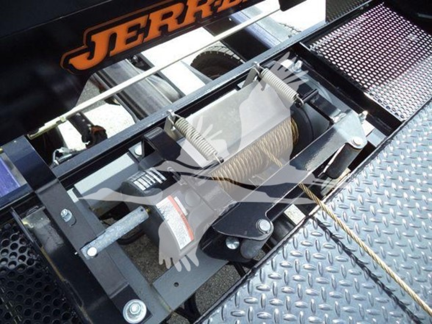 Ford F-550 rollback tow truck winch assembly with steel hook and coiled cable mounting in metal bed.