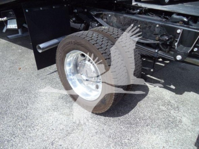 Ford F-550 rollback truck rear wheel and chassis view showing tire, rim, and suspension components.