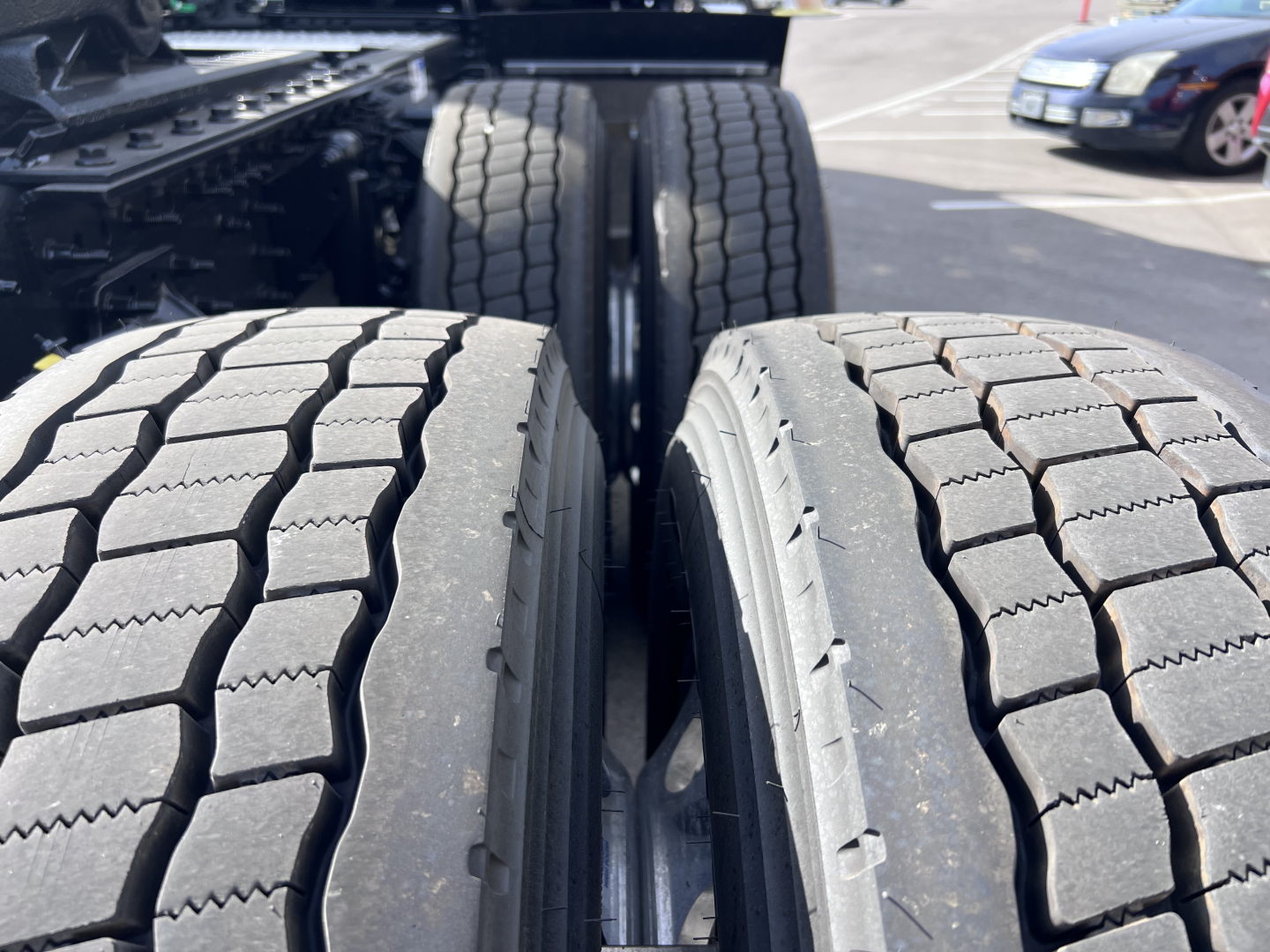Truck axle setup showing dual rear tires and tread pattern on outer tires in the drive axle area.