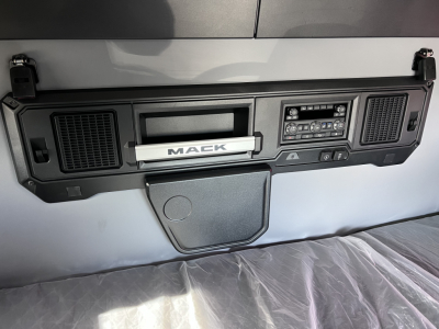 Mack PR64T76H dash/ bunk area showing Mack badge and control panel in central fascia of cab interior.