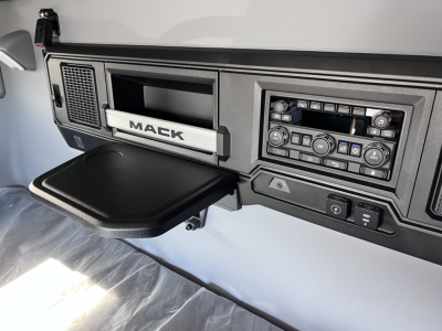 Mack PR64T76H truck interior dashboard showing infotainment, control panel, and cup holder area.