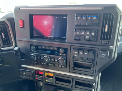 Dashboard of 2026 Mack PR64T76H showing touchscreen display and control panel with climate, media, and rectangular switches.