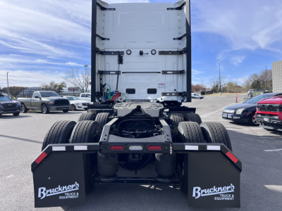 Back view of a Mack PR64T76H tractor chassis showing rear dual axles, fifth wheel area, and mud flaps with Bruckner's Truck & Equipment logos.