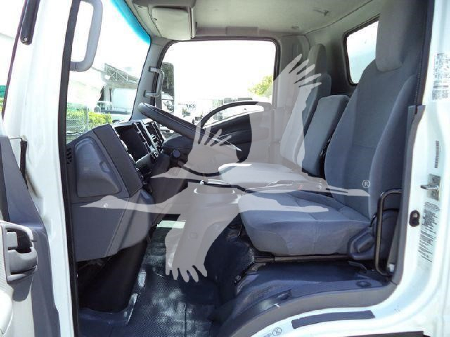 Isuzu NPR HD cab interior showing front seats and dashboard in a box truck