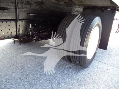 Isuzu NPR-HD truck undercarriage showing dual rear tires and chassis with leaf springs.