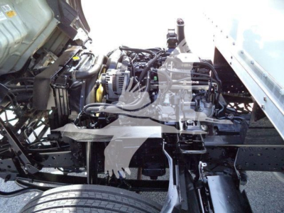 Isuzu NPR-HD truck chassis showing engine bay and frame with exposed components.